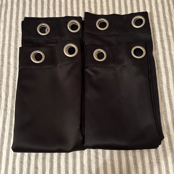 Four (4) black curtain panels. Metal grommets fit rods up to 1.5" in diameter. - Picture 2 of 5